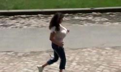 Brunette MILF with giant boobs is running in the park