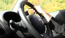 Lovely blonde in black lingerie drives a car in a hot way