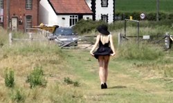 Blonde in black dress and big hat is flashing blue lingerie