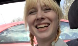 Beautiful smiling blonde is flashing her pussy and grabbing a dildo