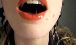 Green-eyed chick with bright red lips poses in doggy style