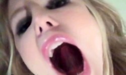 Good-looking blonde smiles in cam and shows off her tongue