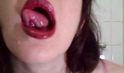 Adorable beauty in pink panties demonstrates her pierced tongue