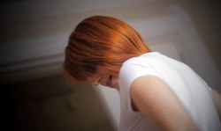 Sweet redhead beauty is lying on the bed and sucking a dick