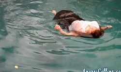 Stunning redhead Anorei Collins is swimming and playing with tits