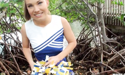 Sweet smiling brunette Cheerleader is performing a good blowjob!