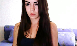 Elegant dark-haired goddess is slowly undressing on the camera