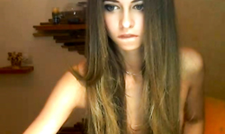 Stunning long-haired teen is playfully undressing on the webcam