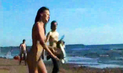 Sexy sling girlfriend is slowly getting naked on the public beach