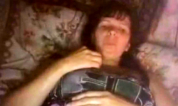 Dark-haired mature is posing and undressing on the camera