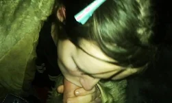 Dark-haired amateur babe is blowing a dick in the night scene