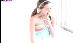 Playful beauty Andi Pink sucks her lollipop in a hot way