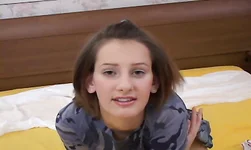 Girl with a wide smile on her face is stroking a hairy puss
