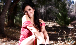 Smiling goddess Denise Milani enjoying posing in the woods