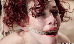 Redhead in extreme bondage finger fucked