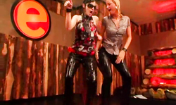 Drunk babes in black leather pants are dancing on stage without shame