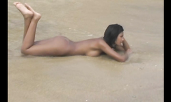 Outstanding brunette Karla Spice is lying fully naked on the beach