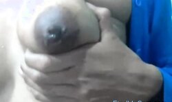 Squeezes out milk from her dark nip ttis