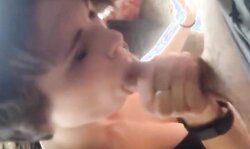 Cute short haired girl with lovely tits gives a blowjob