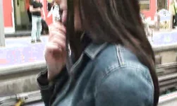 Nerdy girl with short skirt showing her booty with anal toy on public