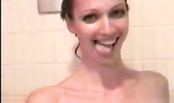 Short-haired cutie is taking shower and posing sexy