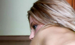 Almost naked leggy blonde is lying in yellow bikini on a green mattress