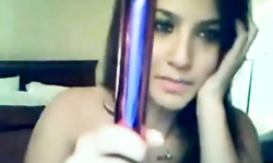 Black-haired beauty with big tits filling her pussy with this purple dildo