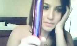 Black-haired beauty with big tits filling her pussy with this purple dildo