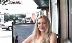 Smiling blonde performs a perfect street blowjob without being shy