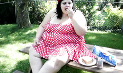 Playful and excited BBW Luna poses outdoors in red dress