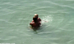 Topless amateur milf is getting spotted on the beach