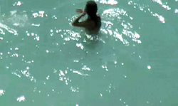 Slender naked babe is lying naked on the beach without being shy