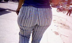 Just filming how a sexy big booty babe in striped pants is walking on the street