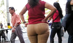Babe in brown pants is having a really perfectly round big booty