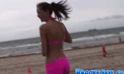 Sporty Brooke Skye poses on the beach in bright pink bikinis