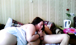 Fatty Russian brunette is lying on the bed and sucking a tasty boner