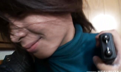 Smiling Japanese schoolgirl is raising up her dress and baring a hairy snatch