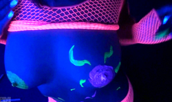 Neon girl Nikki Sims paints on her massive nipples