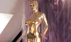 Golden babe with slender body poses fully naked in silver room