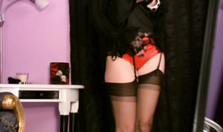 Passionate MILF in black outfit wears sexy black stockings