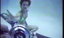 Cutie in bright bikinis poses on the deck chair while being underwater