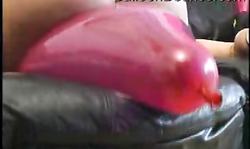 Gorgeous lady with big fat ass jumps on a massive purple balloon