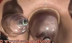 Perfect Domina in black treats her slave with a help of a vacuum toy