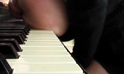 Big-boobed musician Terry Nova is playing on piano