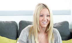 An innocent blonde with big boobies is posing in the doggy style pose