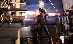 Stunning babe with massive boobies and leather pants poses on the boat