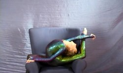 Very flexible and slender young blonde in latex suit