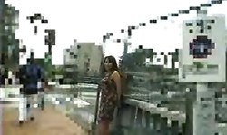 Slutty and playful Asian brunette demonstrates her boobs in public place